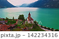 Aerial view of traditional Swiss houses rooftops on the shore of a lake between the Alps in Brienz, Switzerland 142234316