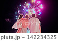 Mother with kids watch the beautiful fireworks on the ocean coast 142234325