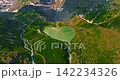 Establishing shot of Switzerland. Aerial view of the green meadows of Switzerland, with the Alps and clouds in the background 142234326
