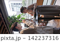 一對年輕的商務人士，一男一女，在咖啡館的站立式桌子旁開會。 142237316