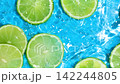 Fresh Lime Slices Floating in Clear Water, Top View, Slow Motion 142244805