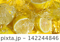 Juicy lemon halves dropping into water causing big splash, slow motion 142244846
