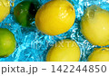 Top view slow motion video of lemons and limes dropping into clear water with splashes 142244850