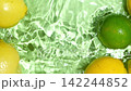 Whole limes falling into water with lemons slow motion splash top view space for text. 142244852