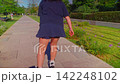 A Young Woman Enjoying a Leisurely Skate Through a Serene Park Path, Embracing Nature and Freedom in a Bright Daylight Setting 142248102