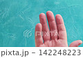 Airport check-in. Quarantine measures. Immigration officer in glove giving passenger passport boarding pass face mask spraying hand with antiseptic loop. 142248223