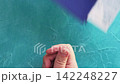 Flight check-in. Quarantine measures. Customs officer in protective glove taking passenger passport boarding pass spraying hand with disinfectant on blue loop. 142248227
