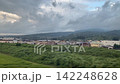 The view from the window of the Shinkansen: a landscape of rice fields and houses. 142248628