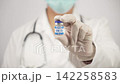Doctor Holding GHK CU Peptide Vial Toward Camera on White Background 142258583