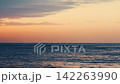 Serene slow motion ocean horizon at golden hour dusk 142263990
