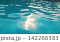 Close up of water caustics in bright blue swimming pool, rippling surface with glinting sunlight reflections, clear turquoise water motion in outdoor pool, relaxing summer vacation and resort 142266383
