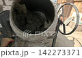 A Close-Up View of a Cement Mixer with Freshly Mixed Concrete, Showcasing the Thick, Muddy Consistency Perfect for Construction Activities and Projects 142273371