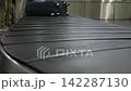 Close up view of the baggage conveyor transporting suitcases at an airport, 4k 142287130