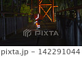 Title: Industrial Worker in High Visibility Suit Sandblasting Bridge Walkway at Night 142291044