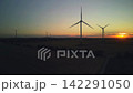 Timelapse of Wind Turbines Fast Spinning at Golden Sunset over Agricultural Fields 142291050