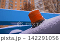 Flashing Orange Beacon Warning Light Covered in Snow Close Up 142291056