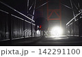 Silhouette of Industrial Worker Sandblasting Walkway at Night Against Bright Backlight 142291100
