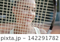 Close up of smiling young female tennis player outdoors 142291782