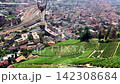 Drone style panoramic shot of historic European city center surrounded by green hills 142308684