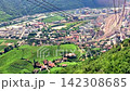 Cinematic view of green alpine vineyards and valley from a moving cable car 142308685