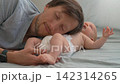 Father listening to his baby son's belly with closed eyes and natural sound. 142314265