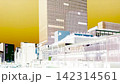 A streetscape in front of Shinjuku Station depicted in an illustrative style. 142314561