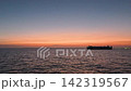 A stock clip featuring ships sailing on the calm ocean in the early morning, against a beautiful sky, evoking images of logistics and maritime transport. A stock clip featuring ships sailing on the calm ocean in the early morning, against a beautiful sky, evoking images of logistics and maritime transport. 142319567