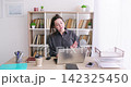 Freelance lifestyle. Office workflow. Happy business woman entrepreneur typing information on laptop at desk at professional workplace indoor. 142325450