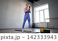 Addicted to smartphone active sporty fit woman practicing squats exercise, strengthening leg and lower body muscles, networking online and text messaging in social media using cellphone during sports 142333943