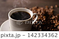 Hot coffee and coffee beans on the table 142334362