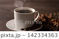 Hot coffee and coffee beans on the table 142334363