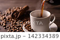 Pour hot coffee into a coffee cup. 142334389