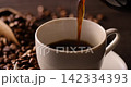 Pour hot coffee into a coffee cup. 142334393