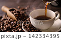 Pour hot coffee into a coffee cup. 142334395