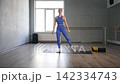 Active graceful fitness woman in sportswear practicing curtsy lunge exercise, flexing and strengthening lower body muscles, improving balance and overall stability during workout in fitness studio. 142334743