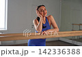 Closeup portrait of sporty fit pretty woman in activewear looking with modest radiant smile, expressing happiness, confidence, natural beauty and wellness while posing indoors. 142336388