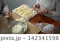 Hands make cheese dumplings. Cook dough food at home. 142341598