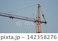 Yellow tower cranes at a construction site of a modern building 142358276