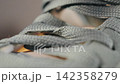 Closeup of textured shoelaces. Highresolution image highlighting detailed craftsmanship of shoelace weaving and stitching 142358279