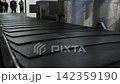 Close up of the baggage conveyor at an airport moving and stopping, 4k 142359190