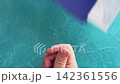 Flight check-in. Quarantine measures. Customs officer in protective glove taking passenger passport boarding pass spraying hand with disinfectant on blue loop. 142361556