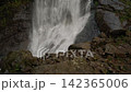 Close-up of a powerful waterfall cascading down dark cliffs. 142365006