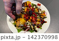 Preparing Colorful Salad With Fresh Dressing 142370998
