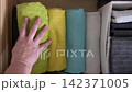 Arranging towel colors and textures in drawer 142371005