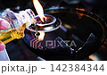 Bangkok, THAILAND - July 16, 2026: People Refilling the oil lamp to ward off bad luck and misfortune and pray respect to The Statue of buddha at temple in Bangkok 142384344