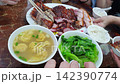 Hong Kong assorted bbq pork duck and crispy pork with vegetabe and wonton 4k 142390774