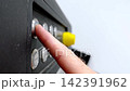Close-up of a hand pressing power buttons 142391962