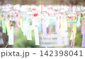 Wind chimes swaying in the summer breeze 142398041