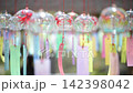 Wind chimes swaying in the summer breeze 142398042