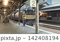 An old-style passenger express train runs on a model railway layout. 142408194